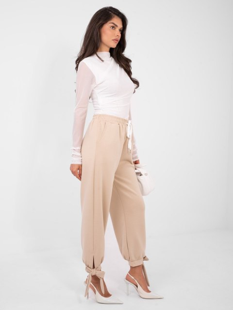 Beżowe spodnie dresowe masełko z wiązanymi nogawkami