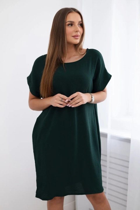 Elegancka ciemnozielona sukienka damska o swobodnym kroju z praktycznymi kieszeniami